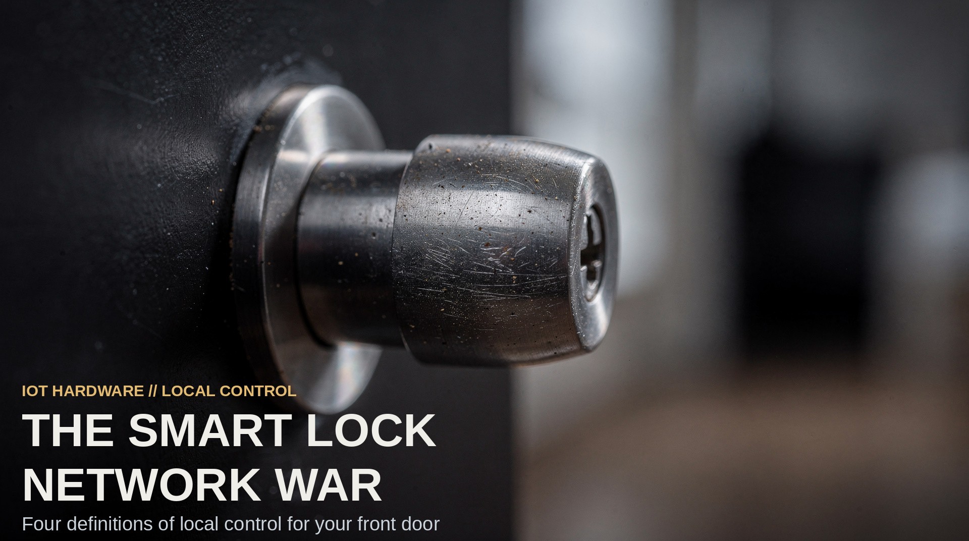 Extreme close-up of a brushed-steel smart deadbolt extending from the edge of a dark front door, lit from one side.